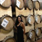 Woman in front of Wine Barrels